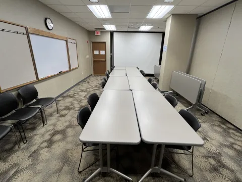Jessie Thomas Meeting Room B has tables, chairs, and a whiteboard available for use. 